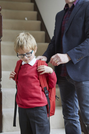 Putting on school bag