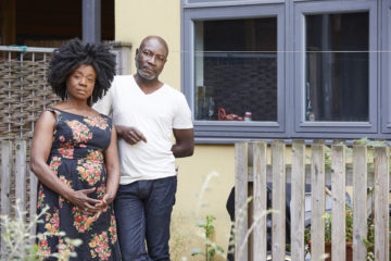 Couple outside their house